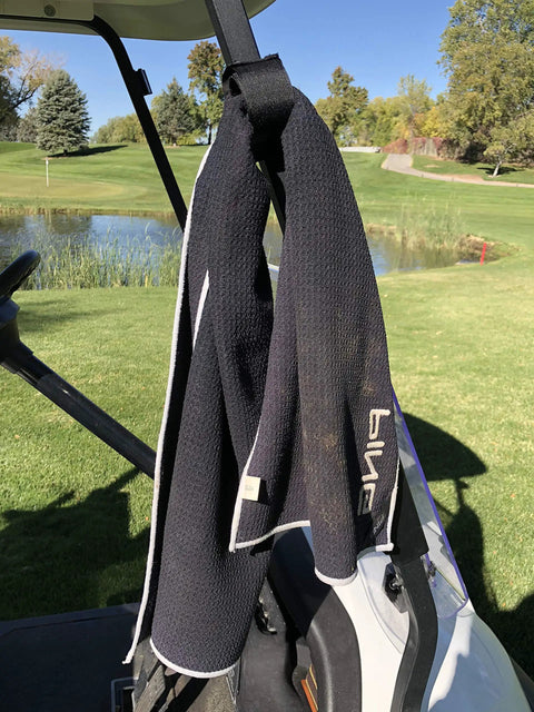 Magnetic Rangefinder Strap For Golf Carts And Rails Adjustable Mount Holder on a golf cart in a scenic golf course setting.