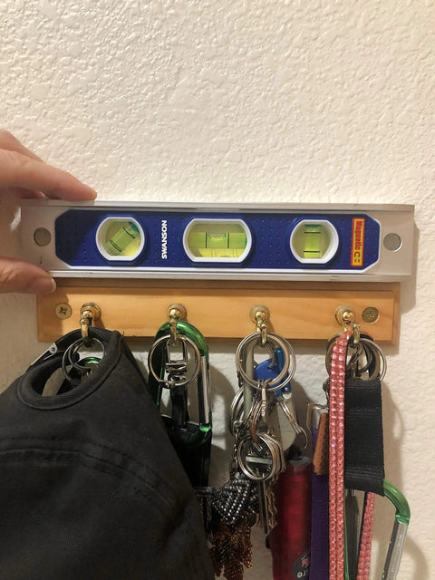 TL002M 9 Inch Magnetic Die Cast Aluminum Torpedo Level With Three Bubble Vials For 0 90 And 45 Degree Measurements on wall hook