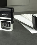 Slick Self Inking Date Stamp With Received Phrase And Dual Color Blue Red Ink Refillable Pad on office desk with stationery.