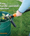 Stand Up 3 Claw Weed Puller with 39 Inch Ergonomic Handle ejecting weeds into a green bag on grass