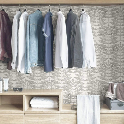 Grey Terrain Botanical Peel And Stick Wallpaper With Scandinavian Influence in a closet setting, showcasing dove leaf pattern.