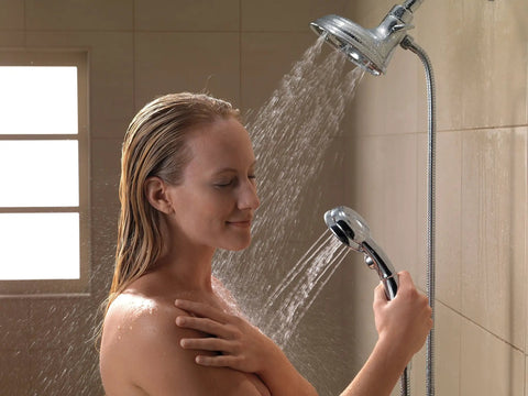 Person enjoying a 4-Spray H2Okinetic In2ition 2-In-1 Dual Handheld Shower Head with Hose and Magnetic Docking, Chrome Finish in use