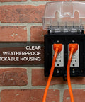 Outdoor Electrical Outlet Cover, Dual Gang Weatherproof Enclosure For Wet Locations, mounted on brick wall with clear cover.