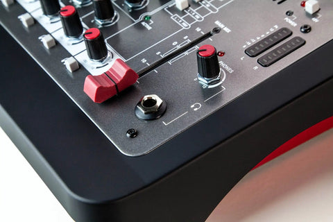 Close-up of ZEDi-8 Compact Hybrid Audio Mixer And USB Interface with visible controls on a black and red panel.