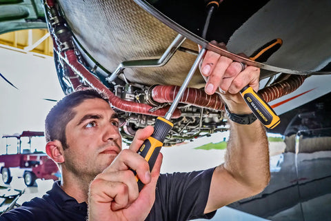 Man using 10 Piece Phillips Slotted Pozidriv Screwdriver Set with Dual Material Handles and Speed Zone Grip in aircraft maintenance
