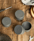 4 Pack Road Ready Rubber Trailer Bearing Dust Caps And Bearing Bras, 1.98 Inch Wheel Hub Covers For Boat Trailers, classic gray rubber caps on a wooden surface.
