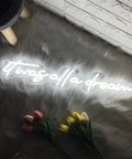It Was All A Dream Neon Sign 3D LED Light With Personalization, displayed on furry rug with pink and yellow flowers
