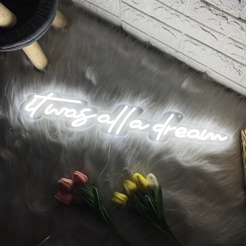 It Was All A Dream Neon Sign 3D LED Light With Personalization, displayed on furry rug with pink and yellow flowers