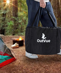 Person carrying tote bag with Stainless Steel Smokeless Fire Pit 19.5 Inch Outdoor Bonfire With Tote Bag And Fire Poker