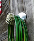 Heavy Duty Aluminum Hose Holder Wall Mount For Outdoor Gardens 200 Foot Reel For Half Inch Hoses on wooden wall
