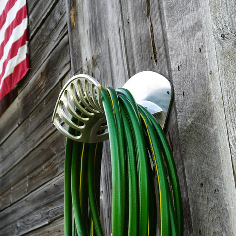 Heavy Duty Aluminum Hose Holder Wall Mount For Outdoor Gardens 200 Foot Reel For Half Inch Hoses on wooden wall