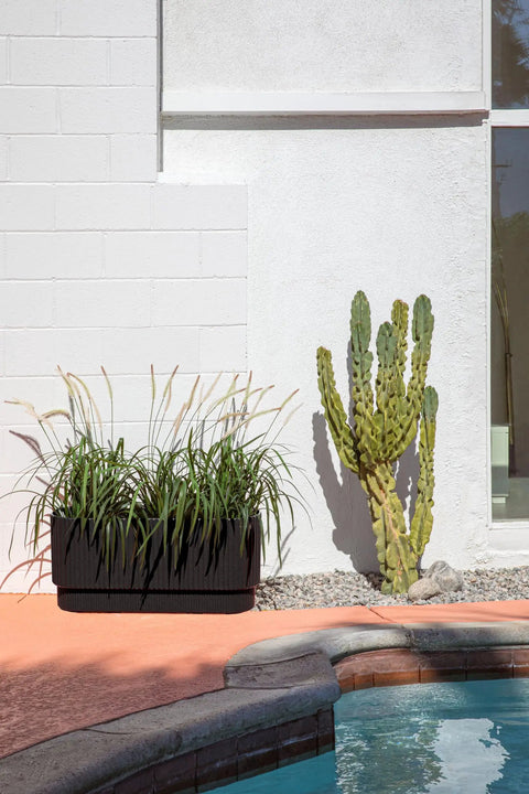 Long Planter For Porch Patio And Backyard In Durable Plastic Stone Composite Fluted All Weather Outdoor Pot For Shrubs And Flowers Modern Decor With Scratch And UV Resistant Finish near cactus and poolside