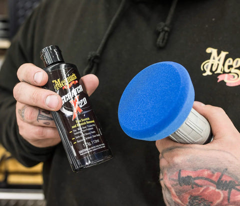 Close-up of Drill Activated Scratch Removal Kit for Light Car Scratches including ScratchX 2.0 and 4 inch pad in hand