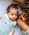 Baby in sky blue Adjustable Baby Swaddle For Newborns That Feels Like The Womb Pediatrician Recommended Safe Sleep Solution