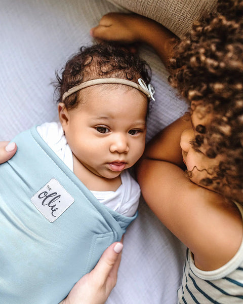 Baby in sky blue Adjustable Baby Swaddle For Newborns That Feels Like The Womb Pediatrician Recommended Safe Sleep Solution