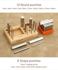 Steel 2.5 Inch Swage Block With 16 Punch Set for jewelry making on wooden stand and rubber base.