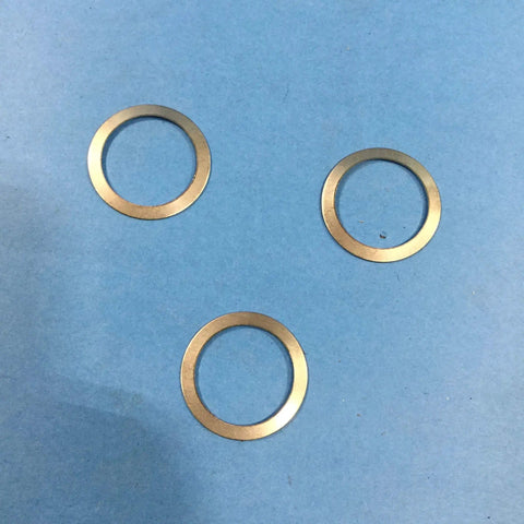 Three metal gaskets from One And A Half Inch Gasket Kit For FT 15 Series Float And Thermostatic Steam Trap 3 Pack Complete Gasket Sets Replacement Seals For Industrial Steam System Part Number 58127 on a blue surface.