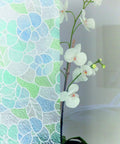 Self Adhesive Privacy Glass Window Film 17 Inch By 78 Inch Roll Stained Glass Blue Green installed on glass with flower visible