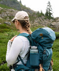 Hiker with teal backpack repaired using Tenacious Tape Repair Patches Peel and Stick Nylon Gear Patches for Jackets Tents Sleeping Bags