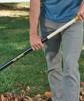 Person using Sturdy Steel Tine Leaf Rake With Hardwood And Steel Handle For Lawns And Dethatching 22 Tines 21.6 Inch Head Black
