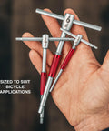 Hand holding Modular T Handle Hex And Torx Wrench Set With 10 Tools In A Portable Space Saving Roll for bike maintenance