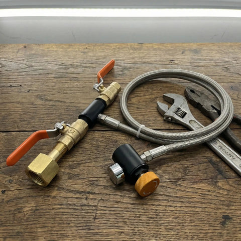 CO2 Refill Adapter for Soda Makers with 24 Inch Stainless Braided Hose, Pressure Gauge and Dual On Off Valves, tools on wood