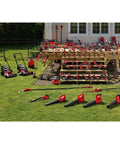 Landscaped backyard with various red power tools, including Beast Bright 2500 Lumen LED Work Light Cordless Spotlight Handheld Rechargeable.