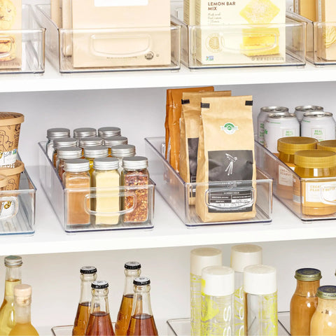 Sleek Extra Long Clear Storage Bins Pack Of 4 Heavy Duty Stackable Plastic Organizers For Deep Pantry Shelves cabinets holding spices, drinks, and snacks.