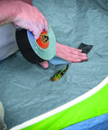 Man using Heavy Duty Black Duct Tape Double Thick Adhesive For Indoor Outdoor Use Grips Rough Surfaces Like Wood Brick