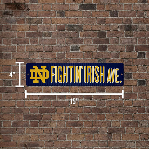 Notre Dame Fighting Irish 16 Inch Plastic Street Sign Wall Decor on brick wall, 4x16 inches, showcasing vivid team logo.