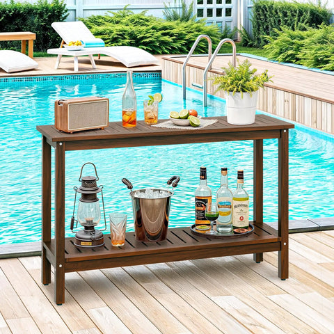 All Weather Patio Bar Table And Console With Two Shelves, 48 Inch Solid Wood Buffet by pool, with drinks and radio on top.