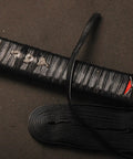 4.4 Yard Synthetic Leather Ito Tsukamaki Sageo Cord For Katana Wakizashi Tanto Scabbard Wrap DIY Handle Renewal Black High Quality Cord For Sword Maintenance displayed with wrapped katana hilt.