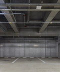 White Surface Mount Fire Extinguisher Cabinet With Clear Pull Cover For Two And A Half Or Five Pound Unit Lock Box on concrete parking structure.