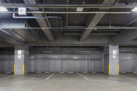 White Surface Mount Fire Extinguisher Cabinet With Clear Pull Cover For Two And A Half Or Five Pound Unit Lock Box on concrete parking structure.