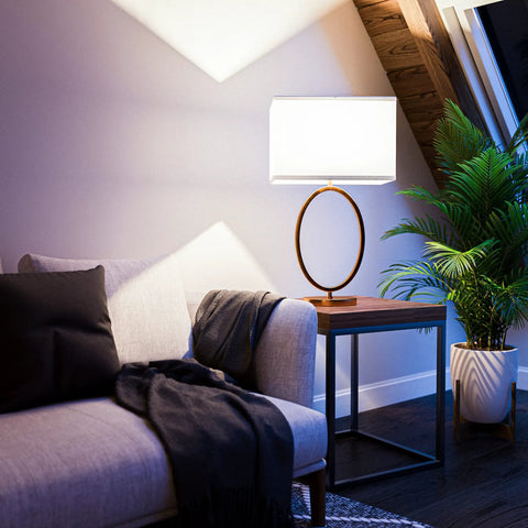 Oke Table Lamp With Gold Plated Finish, Modern Art Deco Open Round Frame, White Rectangular Shade in cozy living room setting.