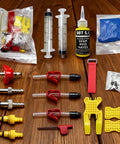 Bike Brake Bleed Kit For All SRAM Series with metal adapters and DOT 5.1 fluid on wooden surface