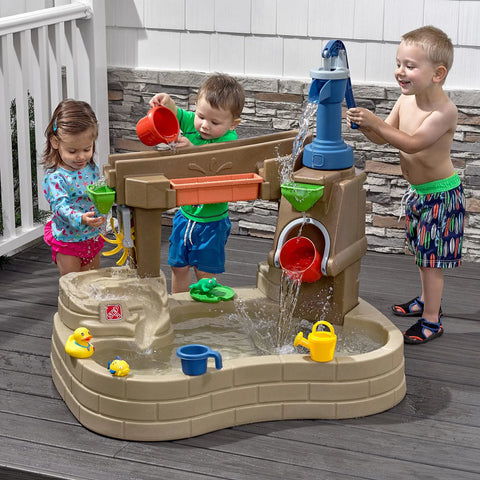 Toddlers playing with Pump And Splash Discovery Water Table For Toddlers 2 Plus With Seats, Kid Friendly Sensory Pool And Outdoor Water Play Set