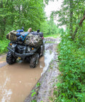 ATV on a muddy trail carrying luggage secured with Heavy Duty Bungee Cord Set Of 12 With Double J Hooks, 32 Inch Elastic Straps