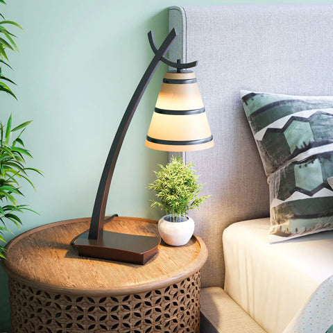Wright 1 Light Table Lamp in Oil Rubbed Bronze Finish on round side table, warm light, amber shade, home office and living room vibe