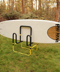 Double Up SUP Stand For Two Boards Holds Two Stand Up Paddle Boards or Surfboards With Durable Foam Padding Yellow in garden