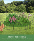No Dig Black Metal Garden Fence Panels Six Pack Decorative Border installed around a flower bed with plants and a cat nearby.