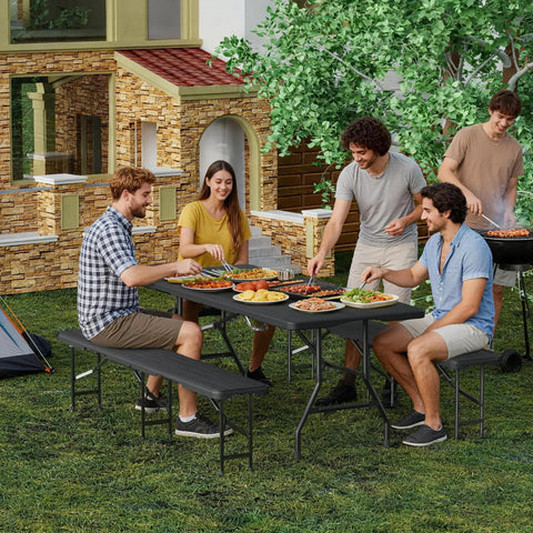 Six Foot Folding Picnic Table Set with Two Benches HDPE Wood Pattern Top used for outdoor dining in a garden setting