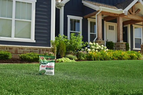 All Grass Types Lawn Fertilizer Twin Pack For 5000 Sq Ft Coverage 12.5 Lb in front of a house with green lawn