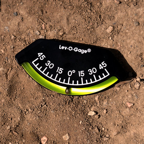 201-F Lev-O-Gage Inclinometer High Visibility Level Gauge with bright display, laying on dirt. Tilt range -45° to 45° USA Made
