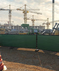 Construction site with 6 ft by 50 ft green fence privacy screen windscreen cover fabric shade netting mesh cloth installed