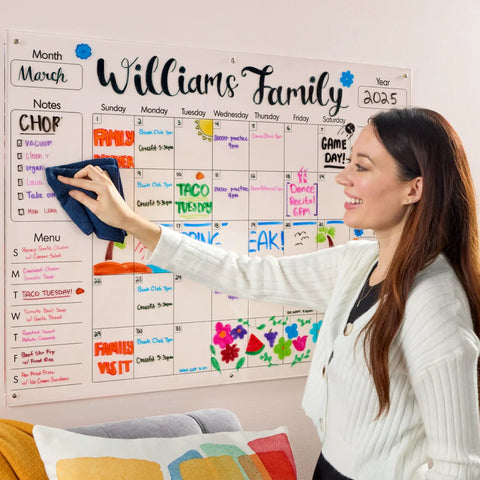 Woman using Dry Erase Whiteboard Cleaner Spray 22oz Eliminates Ghosting And Streaks Easy Wipe on family calendar board