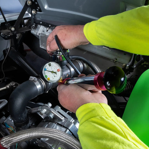 Cooling System Pressure Test Pump Kit For Cars And Trucks, Near Universal Leak Tester in use on car engine