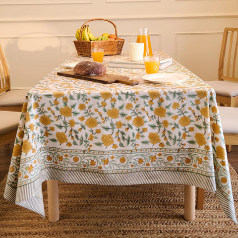 Top Tier Floral Block Print Cotton Tablecloth Yellow Rectangular Dining Cover Washable Farmhouse Kitchen Linen on a dining table.