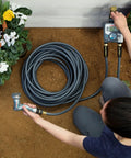 Person using Flexogen 5/8 Inch X 50 Ft Garden Hose Heavy Duty Water Hose, showing flexibility and ergonomic brass couplings