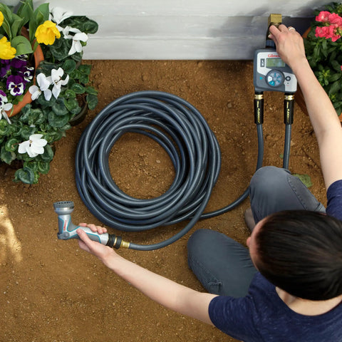 Person using Flexogen 5/8 Inch X 50 Ft Garden Hose Heavy Duty Water Hose, showing flexibility and ergonomic brass couplings